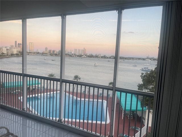 2910 Point E Dr Unit M414, Aventura, FL 33160 - unfurnished sunroom with a water view, a skyline view, and healthy amount of natural light
