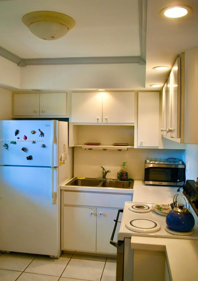 2910 Point E Dr Unit M414, Aventura, FL 33160 - kitchen with white appliances, a sink, light tile patterned floors, light countertops, and open shelves
