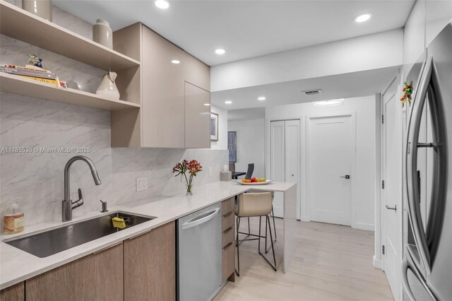 1904 S Ocean Dr Unit 801, Hallandale Beach, FL 33009 - kitchen featuring a breakfast bar area, visible vents, a sink, stainless steel appliances, and modern cabinets