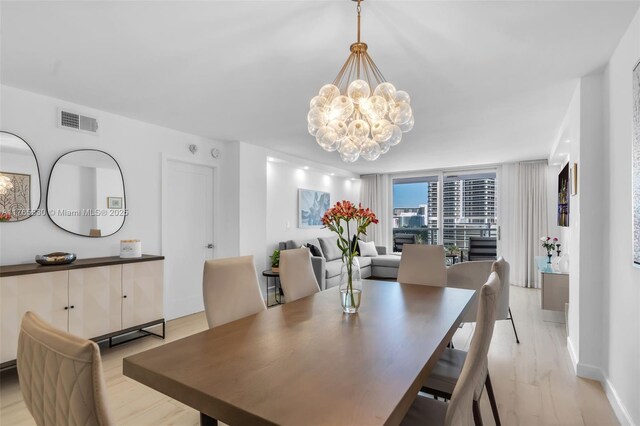 1904 S Ocean Dr Unit 801, Hallandale Beach, FL 33009 - dining area featuring an inviting chandelier, light wood-style flooring, and visible vents