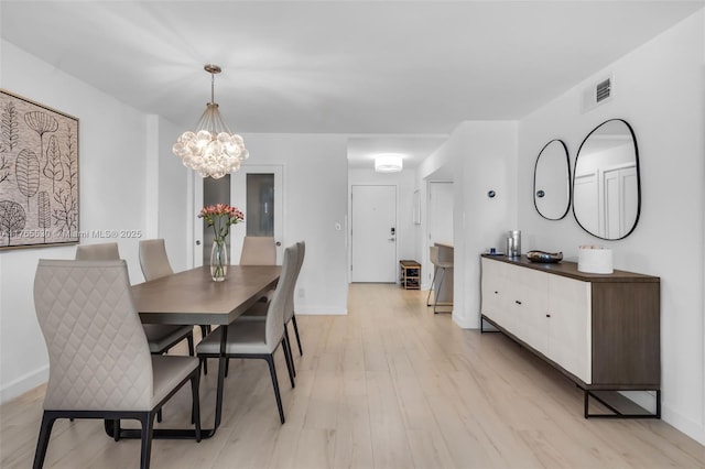 1904 S Ocean Dr Unit 801, Hallandale Beach, FL 33009 - dining area with a chandelier, visible vents, light wood-style flooring, and baseboards