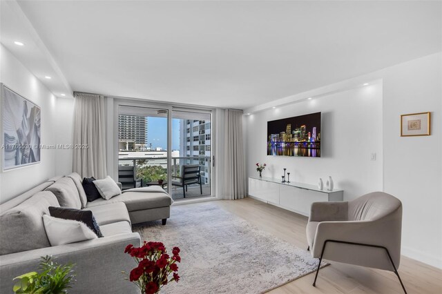 1904 S Ocean Dr Unit 801, Hallandale Beach, FL 33009 - living area with a wall of windows, recessed lighting, and wood finished floors