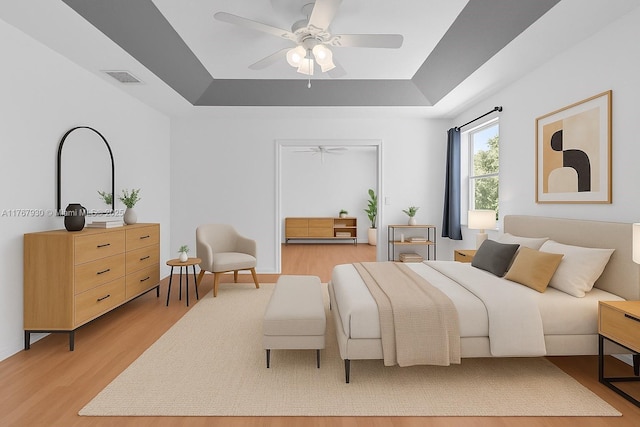 16831 SW 6th St, Pembroke Pines, FL 33027 - bedroom with a tray ceiling, light wood-style floors, and ceiling fan