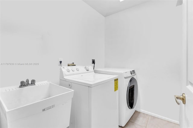 16831 SW 6th St, Pembroke Pines, FL 33027 - washroom featuring washer and clothes dryer, light tile patterned floors, and baseboards