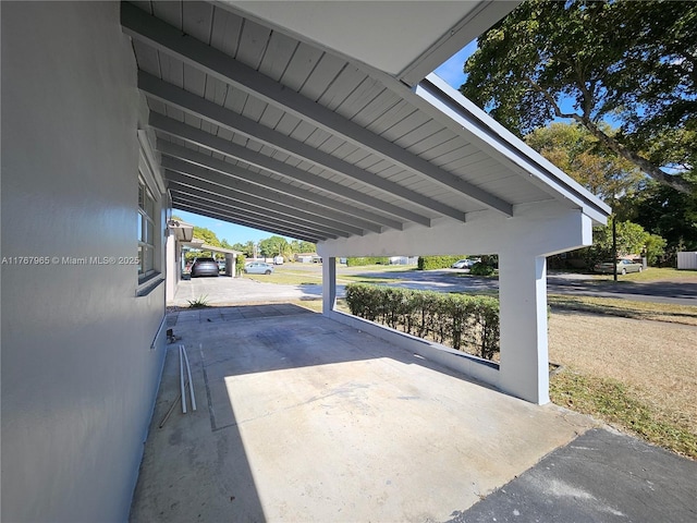 view of parking / parking lot featuring a carport