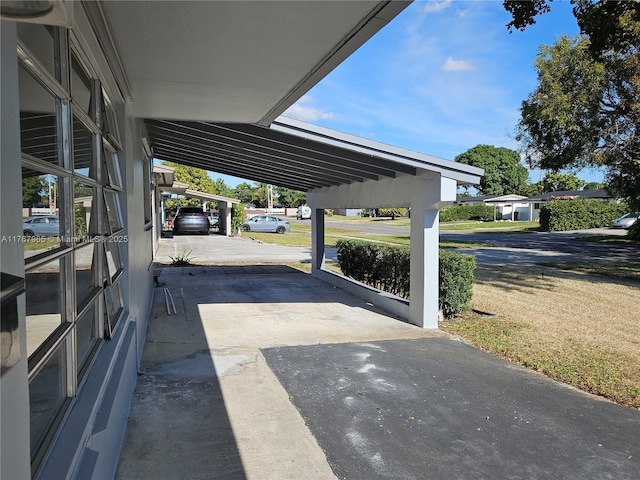 view of car parking with a carport and driveway