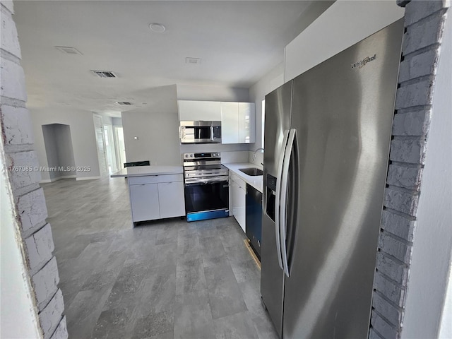 kitchen with visible vents, white cabinets, appliances with stainless steel finishes, and modern cabinets