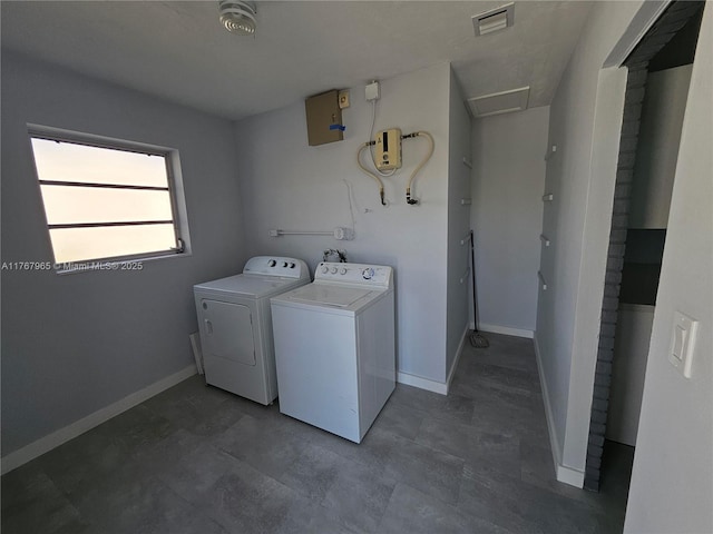 washroom with washer and dryer, visible vents, baseboards, and laundry area