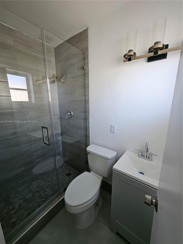 full bath featuring a stall shower, toilet, and vanity