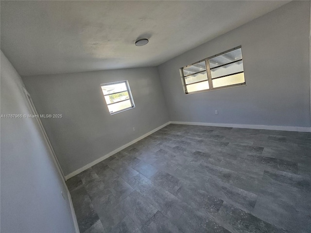 unfurnished room featuring dark wood finished floors and baseboards