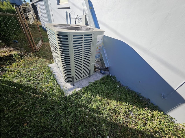 details with central AC unit, fence, and stucco siding
