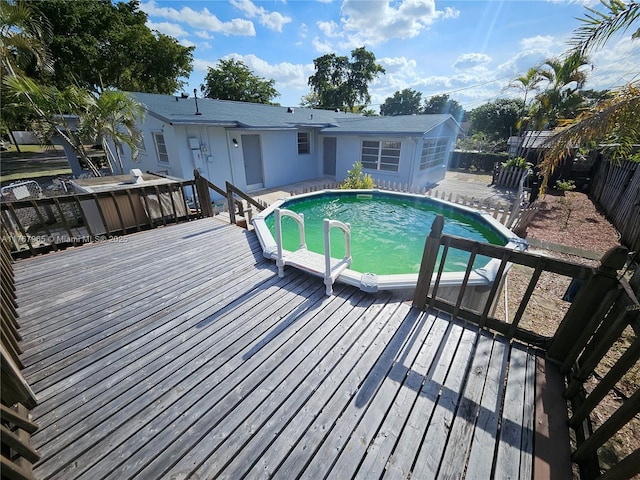 view of swimming pool with a deck, a fenced in pool, and a fenced backyard