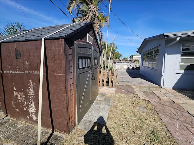 view of shed with fence