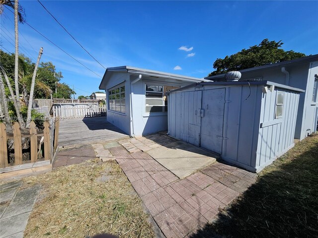 view of outbuilding with an outbuilding and fence