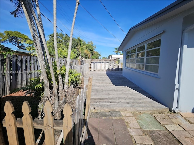 view of patio with a wooden deck and fence