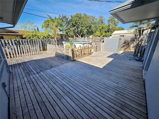 deck with a fenced in pool and a fenced backyard