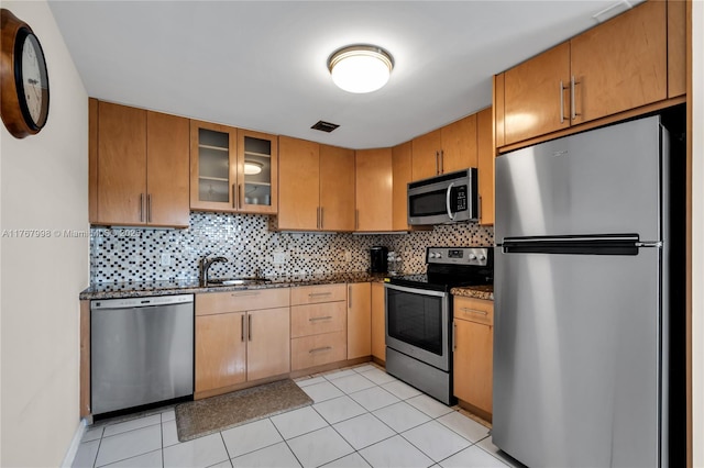4032 Farnham O Unit 4032, Deerfield Beach, FL 33442 - kitchen with appliances with stainless steel finishes, decorative backsplash, glass insert cabinets, dark stone countertops, and a sink