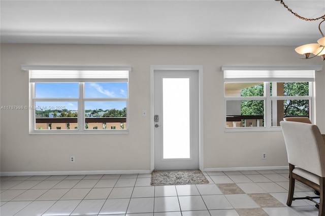 4032 Farnham O Unit 4032, Deerfield Beach, FL 33442 - foyer with baseboards, healthy amount of natural light, light tile patterned floors, and a chandelier