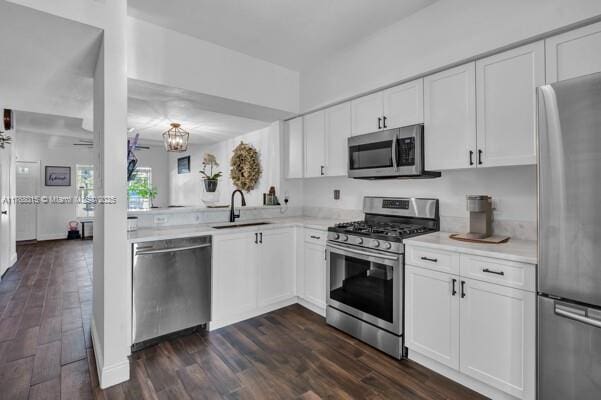 7833 Sanibel Dr Unit 7833, Tamarac, FL 33321 - kitchen with dark wood finished floors, appliances with stainless steel finishes, light countertops, and a sink