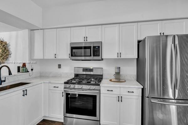 7833 Sanibel Dr Unit 7833, Tamarac, FL 33321 - kitchen with light stone counters, white cabinets, stainless steel appliances, and a sink