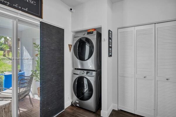 7833 Sanibel Dr Unit 7833, Tamarac, FL 33321 - clothes washing area with baseboards, dark wood-style flooring, and stacked washing maching and dryer