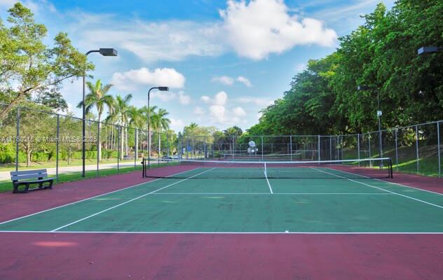7833 Sanibel Dr Unit 7833, Tamarac, FL 33321 - view of tennis court with community basketball court and fence