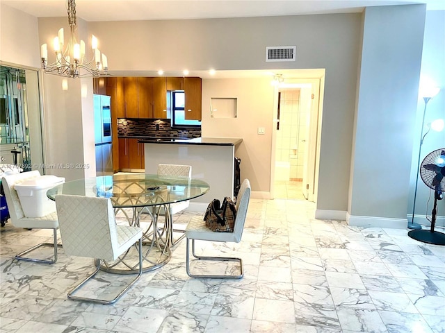 dining space featuring visible vents, baseboards, marble finish floor, and an inviting chandelier