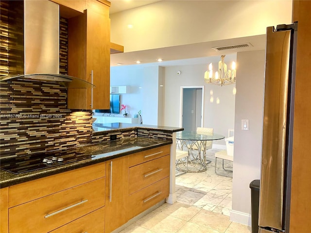 kitchen with visible vents, backsplash, an inviting chandelier, wall chimney exhaust hood, and black electric cooktop