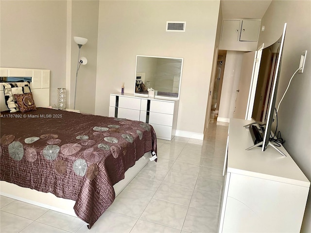 bedroom featuring light tile patterned floors and visible vents