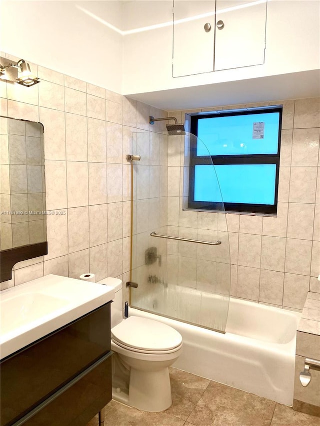 full bathroom with vanity, washtub / shower combination, tile walls, toilet, and tile patterned floors