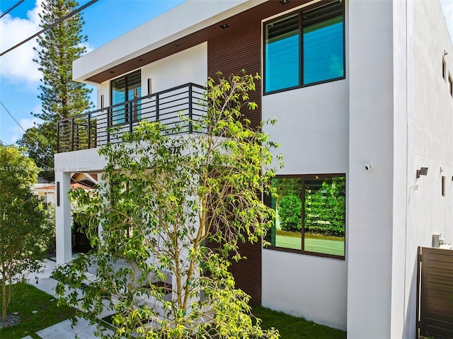 2572 NE 182nd Ter, North Miami Beach, FL 33160 - view of property exterior with a patio, a balcony, and stucco siding