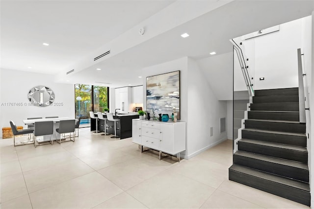 2572 NE 182nd Ter, North Miami Beach, FL 33160 - interior space featuring a wall of windows, light tile patterned floors, visible vents, recessed lighting, and stairs