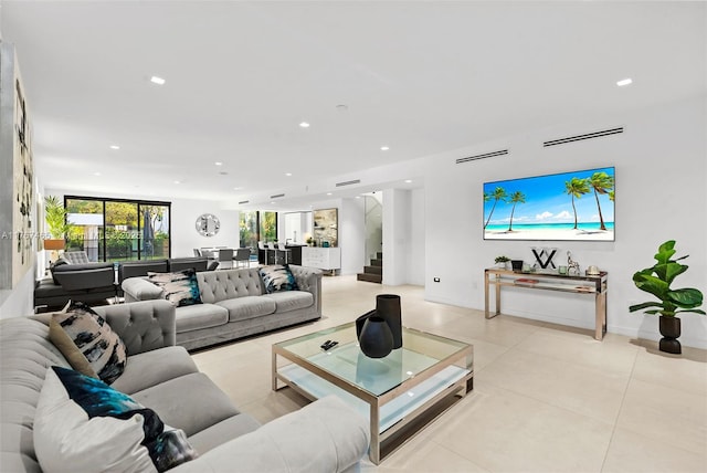2572 NE 182nd Ter, North Miami Beach, FL 33160 - living room with stairs, light tile patterned floors, recessed lighting, and baseboards