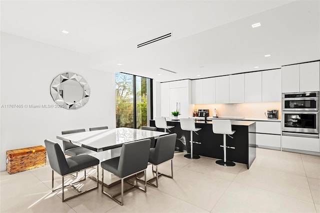 2572 NE 182nd Ter, North Miami Beach, FL 33160 - dining space featuring light tile patterned floors, visible vents, recessed lighting, and expansive windows
