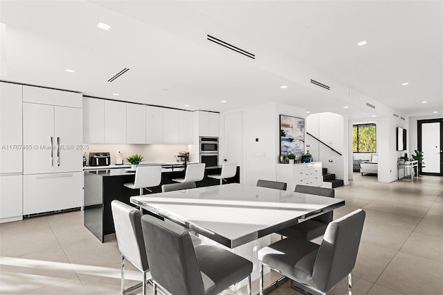 2572 NE 182nd Ter, North Miami Beach, FL 33160 - dining area with stairs, light tile patterned floors, recessed lighting, and visible vents