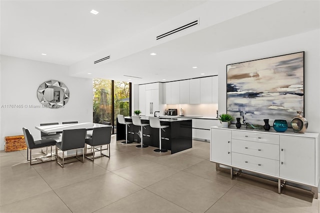 2572 NE 182nd Ter, North Miami Beach, FL 33160 - dining space featuring recessed lighting, visible vents, and expansive windows