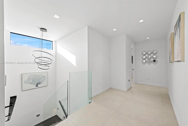 2572 NE 182nd Ter, North Miami Beach, FL 33160 - hall featuring a notable chandelier and baseboards