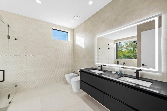 2572 NE 182nd Ter, North Miami Beach, FL 33160 - bathroom with tile walls, a bidet, a stall shower, and a sink