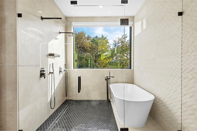 2572 NE 182nd Ter, North Miami Beach, FL 33160 - full bath with tile walls, a freestanding tub, tile patterned floors, and tiled shower
