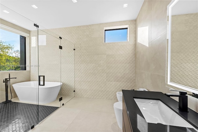 2572 NE 182nd Ter, North Miami Beach, FL 33160 - full bathroom with a freestanding bath, a shower stall, tile walls, toilet, and tile patterned floors
