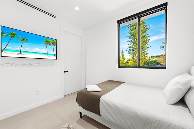 2572 NE 182nd Ter, North Miami Beach, FL 33160 - bedroom with baseboards and finished concrete floors