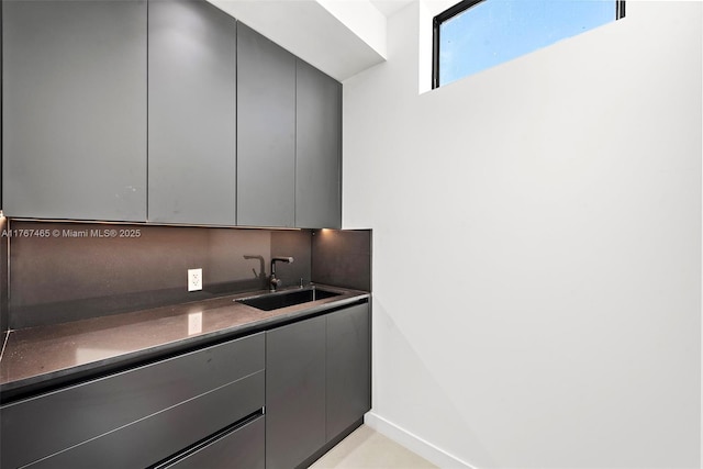 2572 NE 182nd Ter, North Miami Beach, FL 33160 - kitchen with a sink, modern cabinets, dark countertops, and gray cabinetry