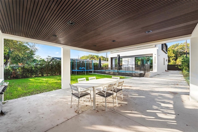 2572 NE 182nd Ter, North Miami Beach, FL 33160 - view of patio featuring outdoor dining space, a trampoline, fence, and a fenced in pool