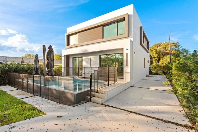 2572 NE 182nd Ter, North Miami Beach, FL 33160 - back of house featuring a patio area, a fenced in pool, and stucco siding