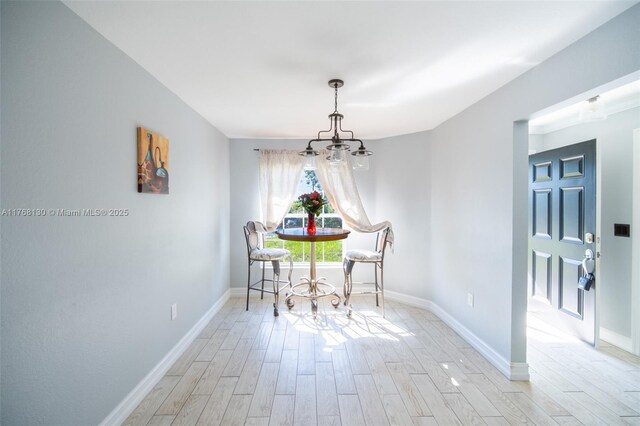 3705 NE 15th Ave, Cape Coral, FL 33909 - dining space featuring light wood-type flooring, baseboards, and an inviting chandelier