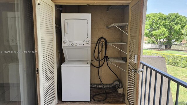13715 Kendale Lakes Cir Unit A-201, Miami, FL 33183 - laundry area with stacked washing machine and dryer and healthy amount of natural light