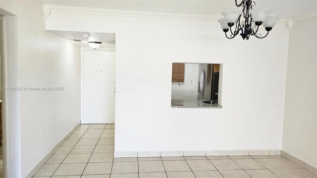 13715 Kendale Lakes Cir Unit A-201, Miami, FL 33183 - unfurnished dining area with crown molding, tile patterned flooring, a chandelier, and baseboards