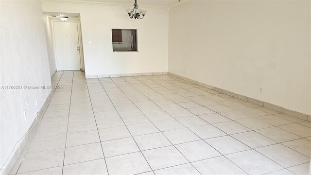 13715 Kendale Lakes Cir Unit A-201, Miami, FL 33183 - empty room with ornamental molding, light tile patterned floors, and a chandelier