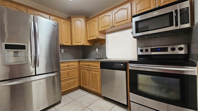 13715 Kendale Lakes Cir Unit A-201, Miami, FL 33183 - kitchen with appliances with stainless steel finishes, a sink, light tile patterned floors, and backsplash