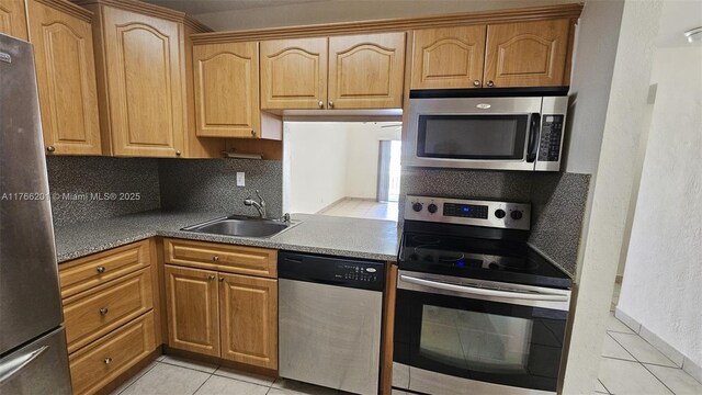 13715 Kendale Lakes Cir Unit A-201, Miami, FL 33183 - kitchen featuring appliances with stainless steel finishes, a sink, and light tile patterned floors